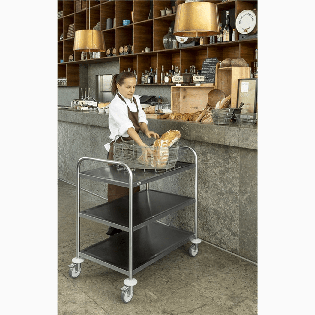 Rostfri vagn, 3 hyllor, 710x400x805mm, 100kg i restaurangmiljö med bagare som lastar bröd.